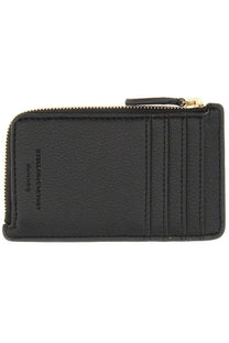 Black leather zippered card case with gold-tone zipper pull and embossed Stella McCartney brand name