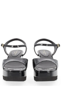Stella McCartney women’s Elyse black patent leather platform sandals with glossy finish and gold-tone buckle details