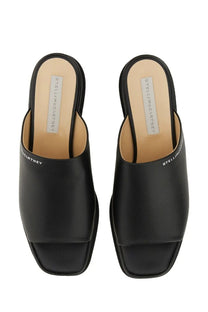 Stella mccartney women’s black leather mules with sleek minimalist design and bold platform sole front view