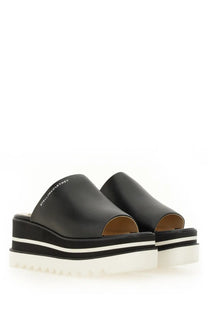Stella McCartney women’s black leather slide-on platform sandals with white and black striped sole
