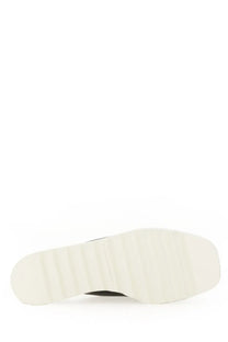 White rubber sole with textured ribbed pattern on the back of Stella McCartney women’s sandal sneak Elyse eco black
