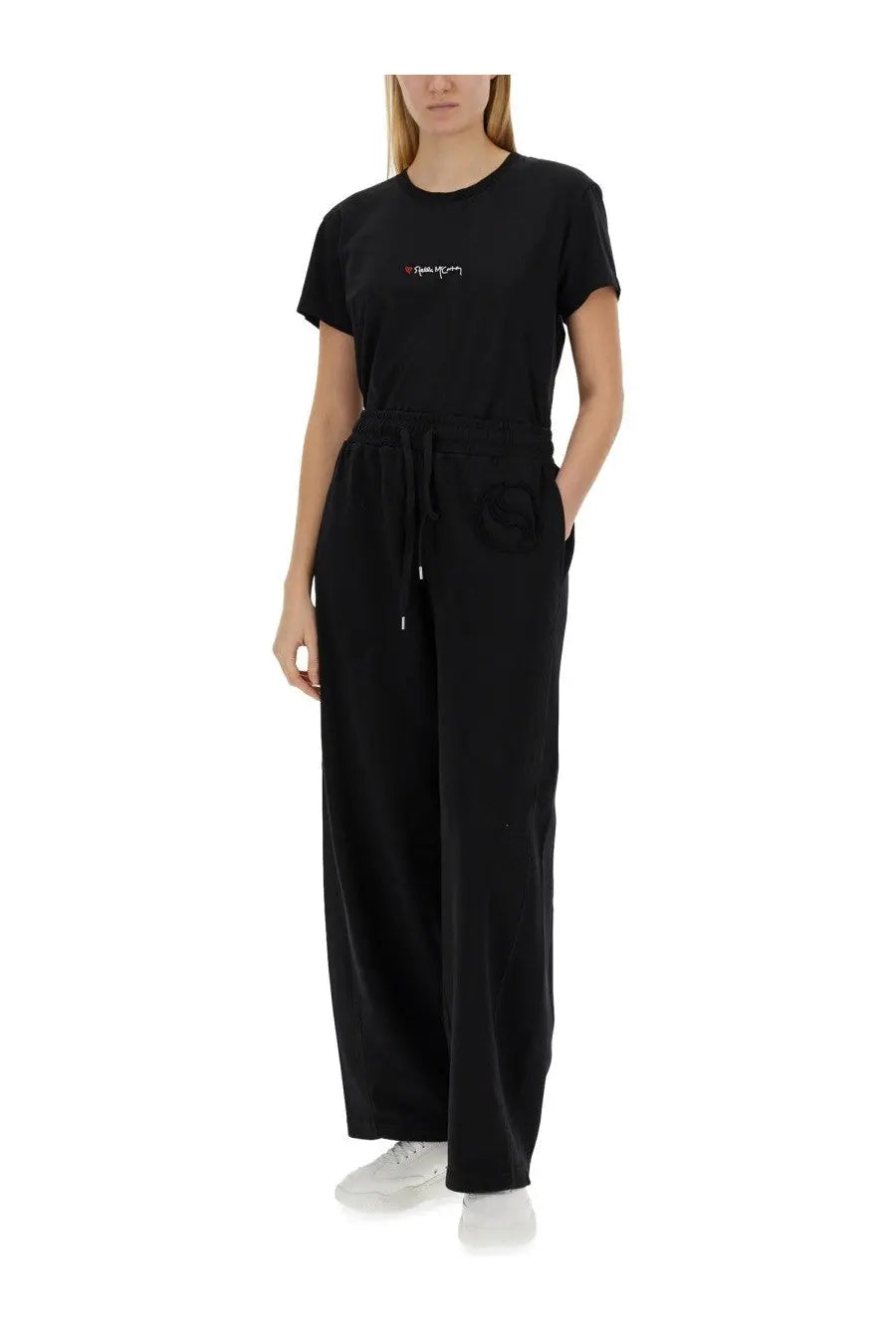 Black cotton jogger pants with drawstring waist and side pockets styled with stella mccartney women’s shirt black