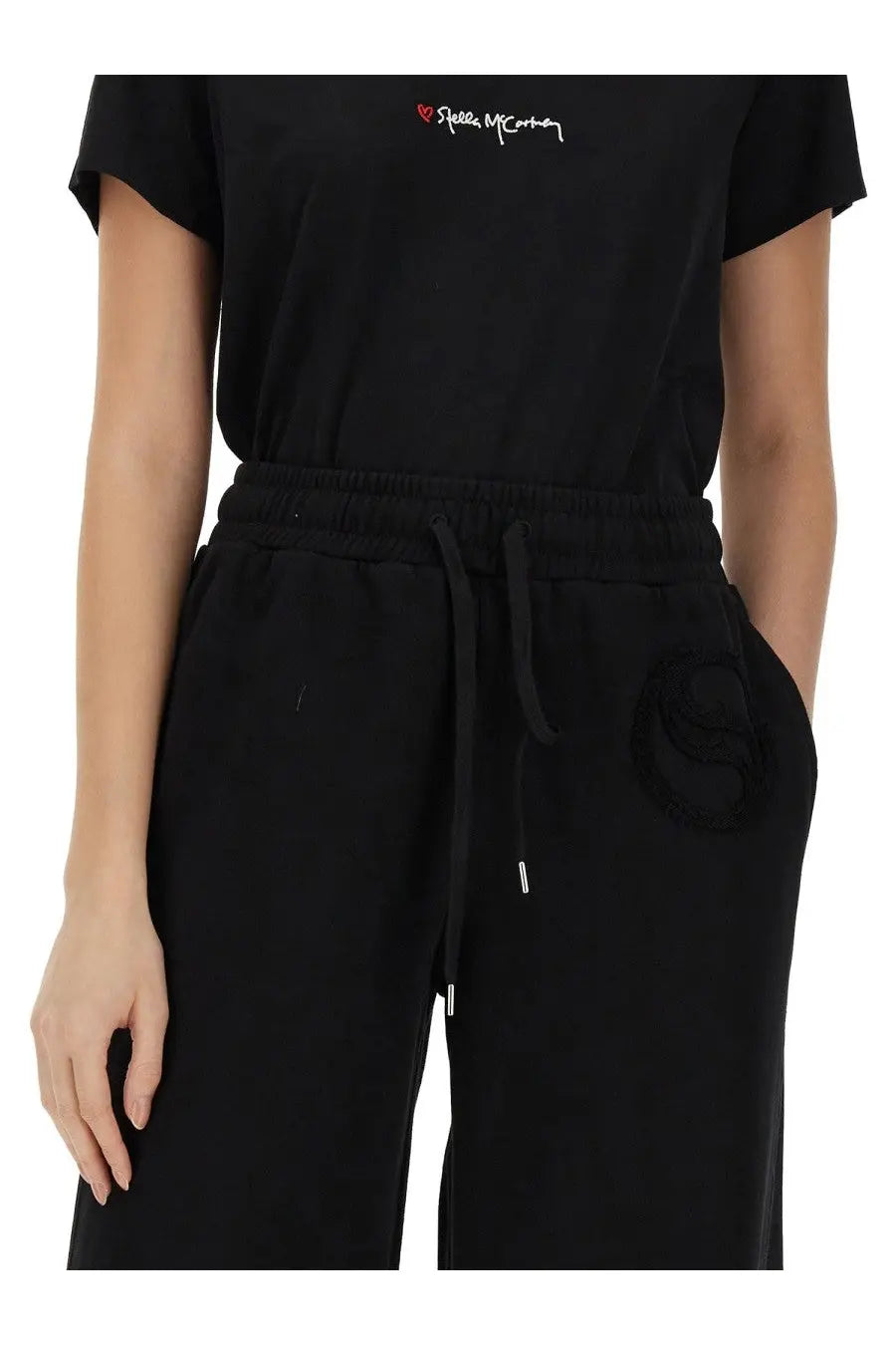Stella mccartney women’s black cotton joggers with drawstring waist and subtle embroidered logo on left thigh