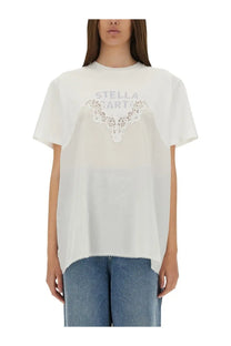 Stella McCartney women’s white t-shirt with delicate lace detailing across the chest and a slightly asymmetrical hem