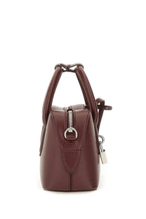A structured burgundy leather mini shoulder bag by Stella McCartney with a top handle and silver zipper closure