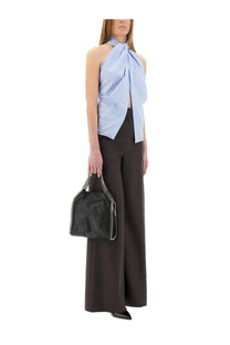 Black leather handbag with textured surface and silver chain strap paired with Stella McCartney blue sleeveless top