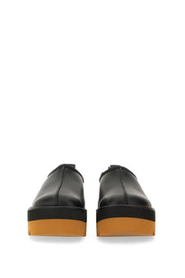 Stella McCartney women’s black leather slip-on platform shoes with bold orange rubber sole front view