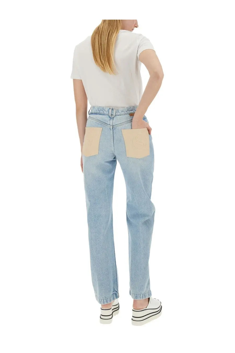 Stella McCartney women’s straight leg light-wash denim jeans with contrasting beige patch pockets shown from the back