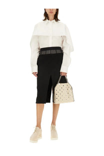 Cream-colored leather handbag with black polka dots and chain strap paired with stella mccartney womens wool skirt black