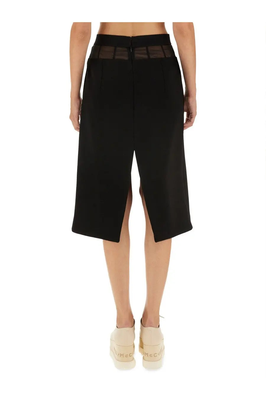 Back view of black stella mccartney women’s wool skirt with high-waisted design and sheer mesh panel at waistband