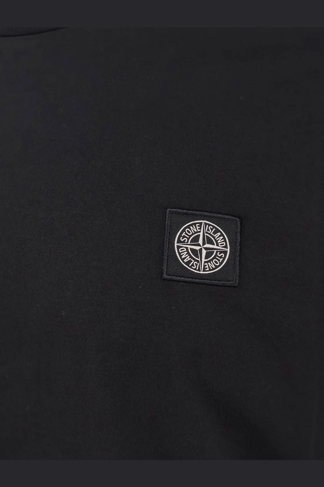 Stone island men’s black cotton shirt featuring a white embroidered compass logo patch on a black stone island jacket
