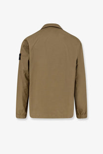 Stone Island men’s tan utility jacket with subtle textured weave elasticated cuffs and black patch on left sleeve