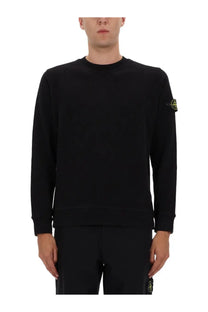 Stone Island men’s black cotton long-sleeved crewneck sweatshirt with small yellow logo patch on left sleeve