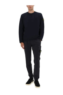 Stone island men’s cotton sweatshirt in black with a subtle yellow logo on the left sleeve and matching cargo pants