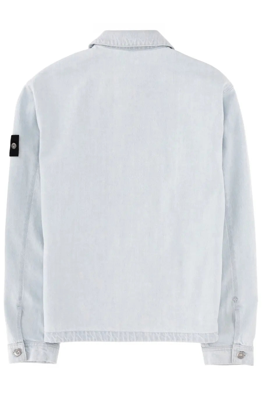 Stone Island men’s light blue denim jacket with black sleeve patch featuring a silver emblem