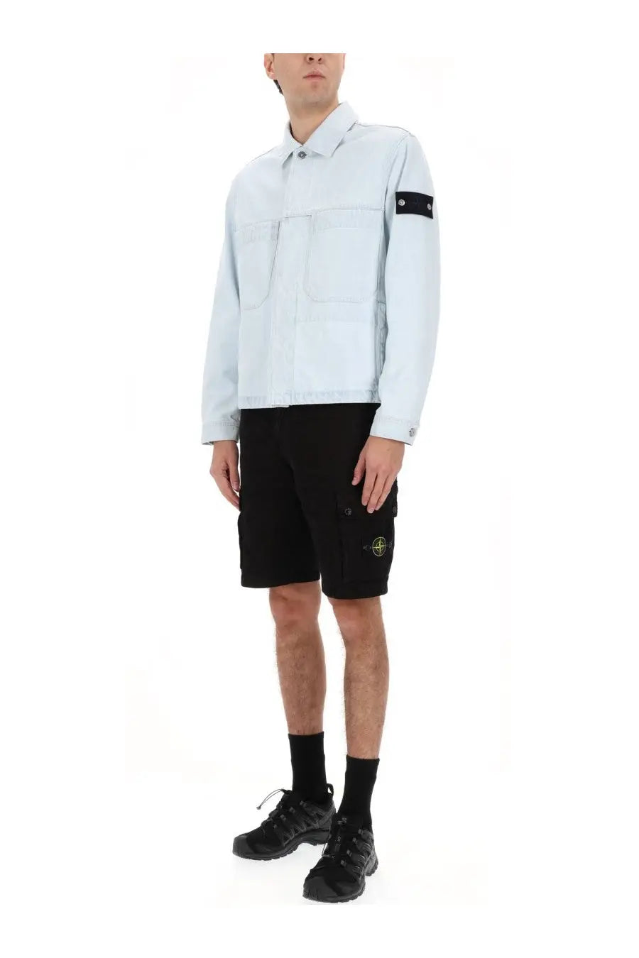 Stone Island men’s light blue denim jacket with black sleeve patch and front pockets in blue denim material