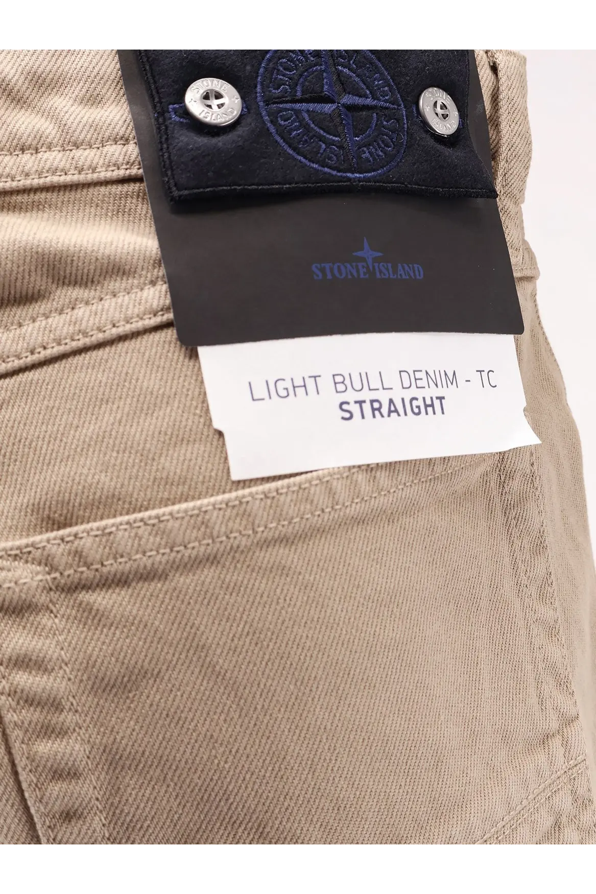 Stone Island men’s beige light bull denim jeans with black label and silver buttons in desert color