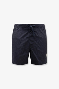 Stone island men’s econylon swim trunks in dark navy blue with elastic waistband drawstring and white logo on lower right leg