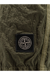 Olive green textured fabric patch with black embroidered stone island compass logo on men’s econylon swim trunks