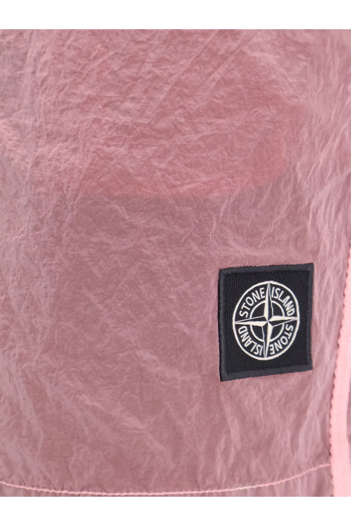 Pink textured fabric with black stone island logo patch on stone island men’s econylon swim trunks