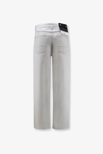 Stone Island men’s faded effect jeans in blue featuring light gray wide-leg denim trousers with subtle stitching details