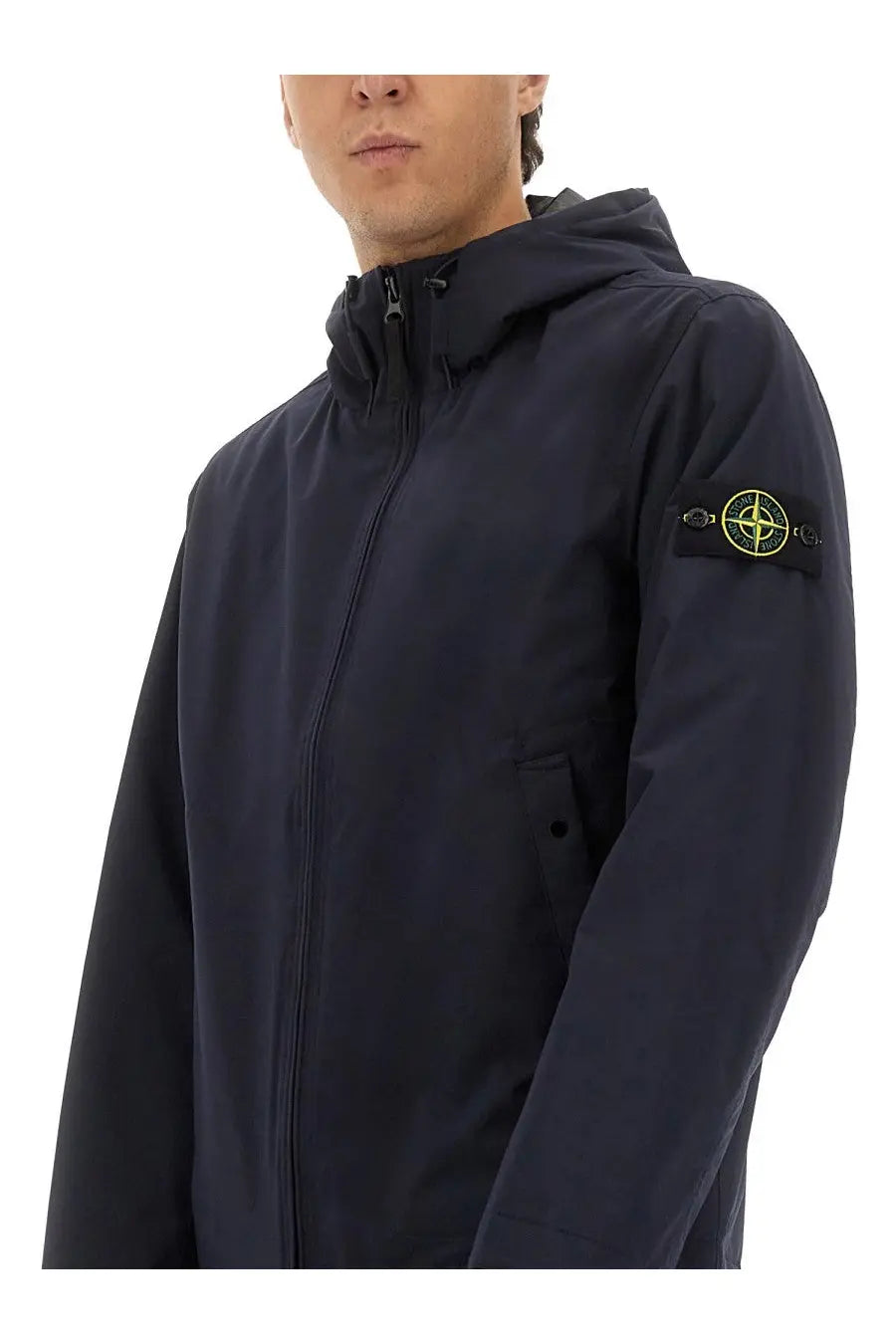 Stone Island men’s dark navy blue hooded jacket with a yellow logo patch on the left sleeve designed for casual wear