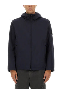 Stone Island men’s dark navy blue hooded jacket with sleek modern design and subtle branding on the sleeve