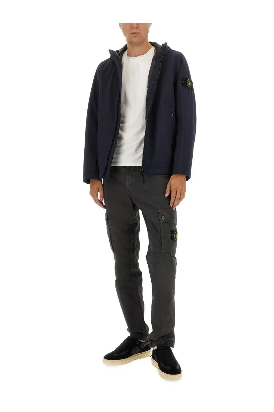 Stone Island men’s hooded jacket in navy blue with subtle textured fabric and yellow logo patch on the sleeve