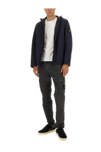 Stone Island men’s hooded jacket in navy blue with subtle textured fabric and yellow logo patch on the sleeve
