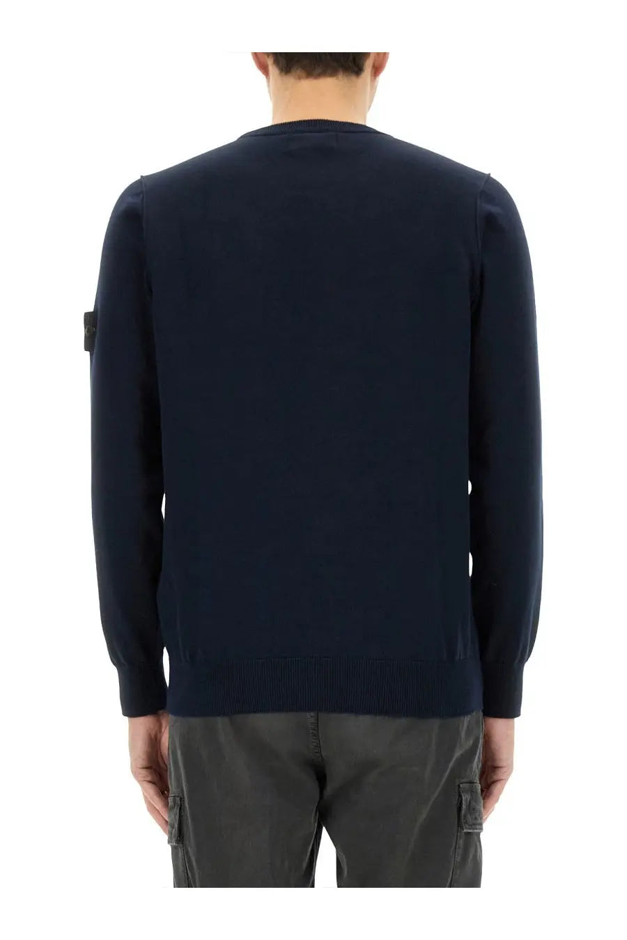 Stone Island men’s navy blue knit sweater with ribbed hem and cuffs featuring a black patch on the left sleeve