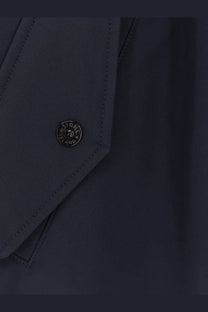 Dark navy stone island button with circular metallic emblem on men’s light soft shell edye technology jacket blue