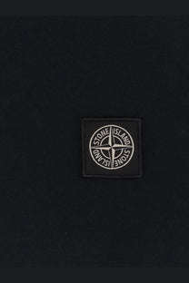 Black stone island patch with white embroidered logo on dark fabric on stone island mens organic cotton blue polo shirt