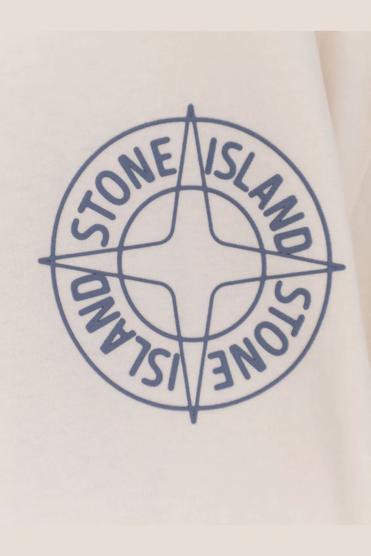 Blue embroidered stone island compass logo on cream-colored fabric of stone island men’s organic cotton white shirt