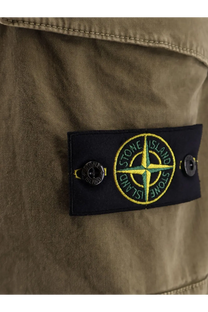 Black embroidered Stone Island patch with yellow green compass rose on olive green organic cotton shorts