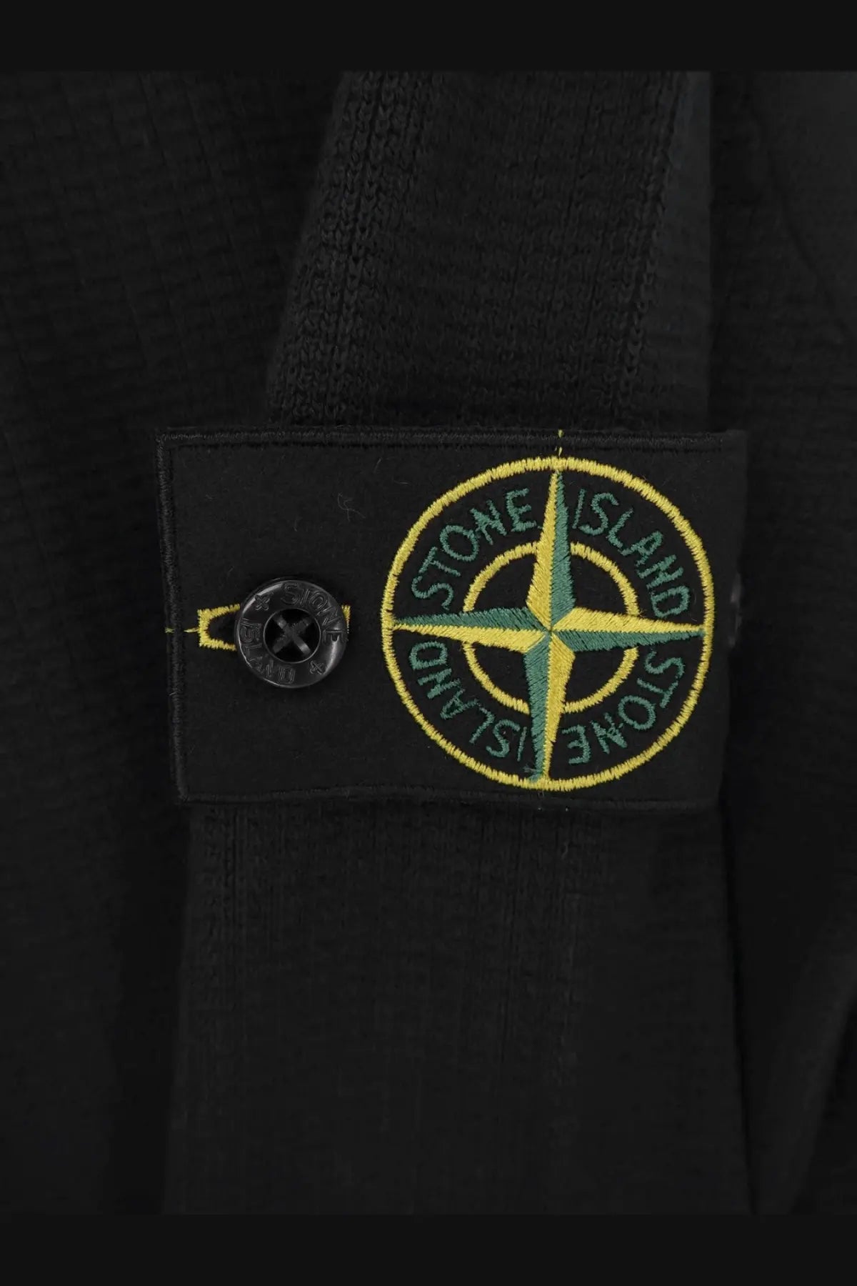 Stone island men’s organic cotton sweater black featuring black stone island patch with yellow and green compass rose embroidery