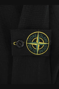 Stone island men’s organic cotton sweater black featuring black stone island patch with yellow and green compass rose embroidery