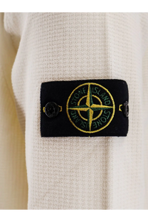Black embroidered patch with green and yellow compass rose and stone island logo on white organic cotton sweater for men