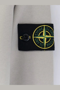 Stone island men’s organic cotton sweatshirt white with black embroidered patch and yellow green compass rose on beige sleeve