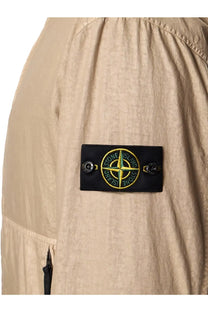 Beige stone island jacket sleeve patch with yellow compass rose and green stone island text on desert nylon panama tc jacket