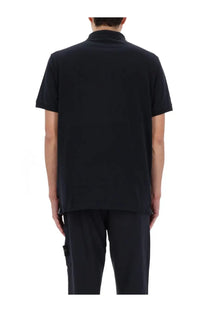 Stone Island men’s polo blue featuring a black short-sleeved classic collar shirt with subtle side seam detailing
