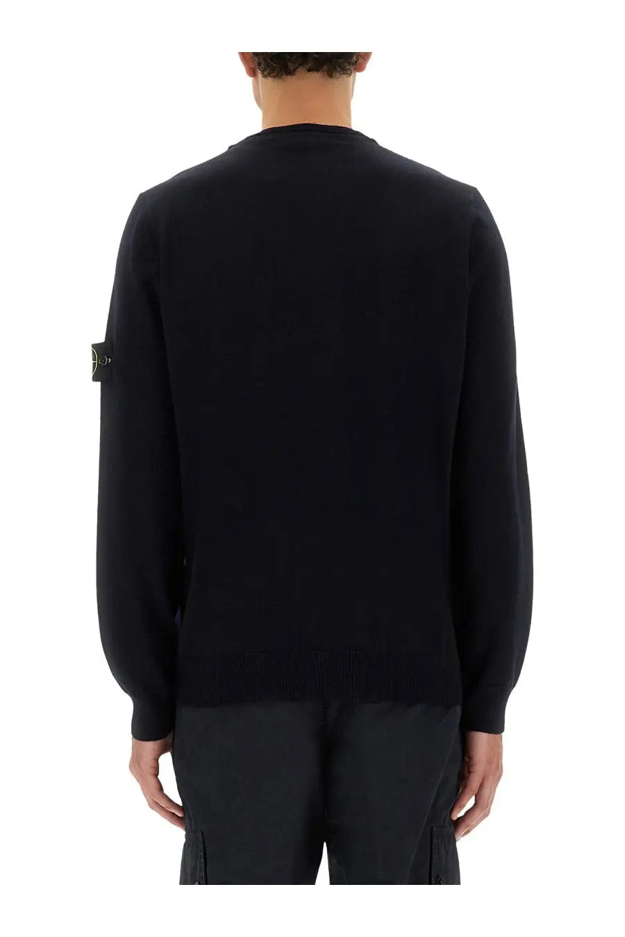 Stone Island men’s black knit sweater with ribbed crew neck and cuffs featuring logo patch on left sleeve