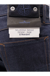 Stone Island men’s selvedge indigo jeans in dark blue raw denim with orange stitching and a black branded label