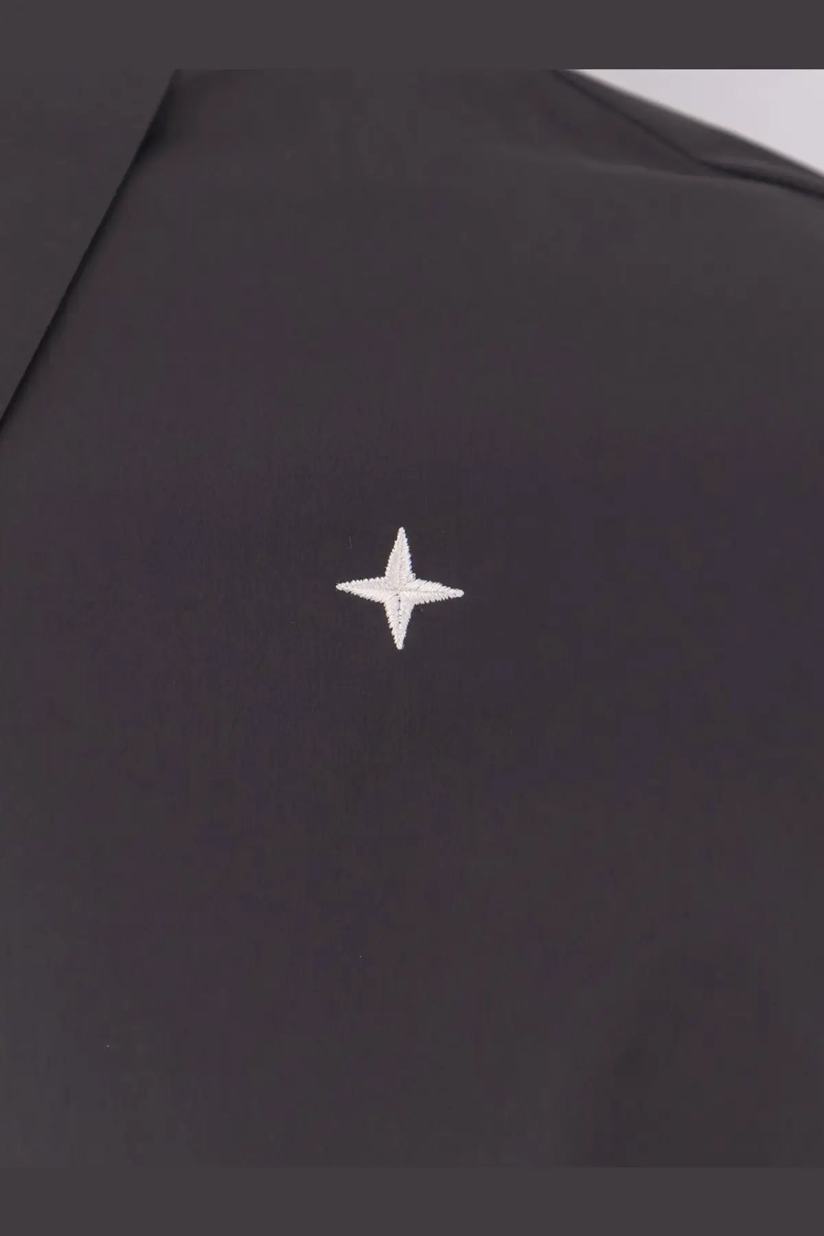 Stone Island men’s grey shirt featuring a small white embroidered star patch on black fabric detail