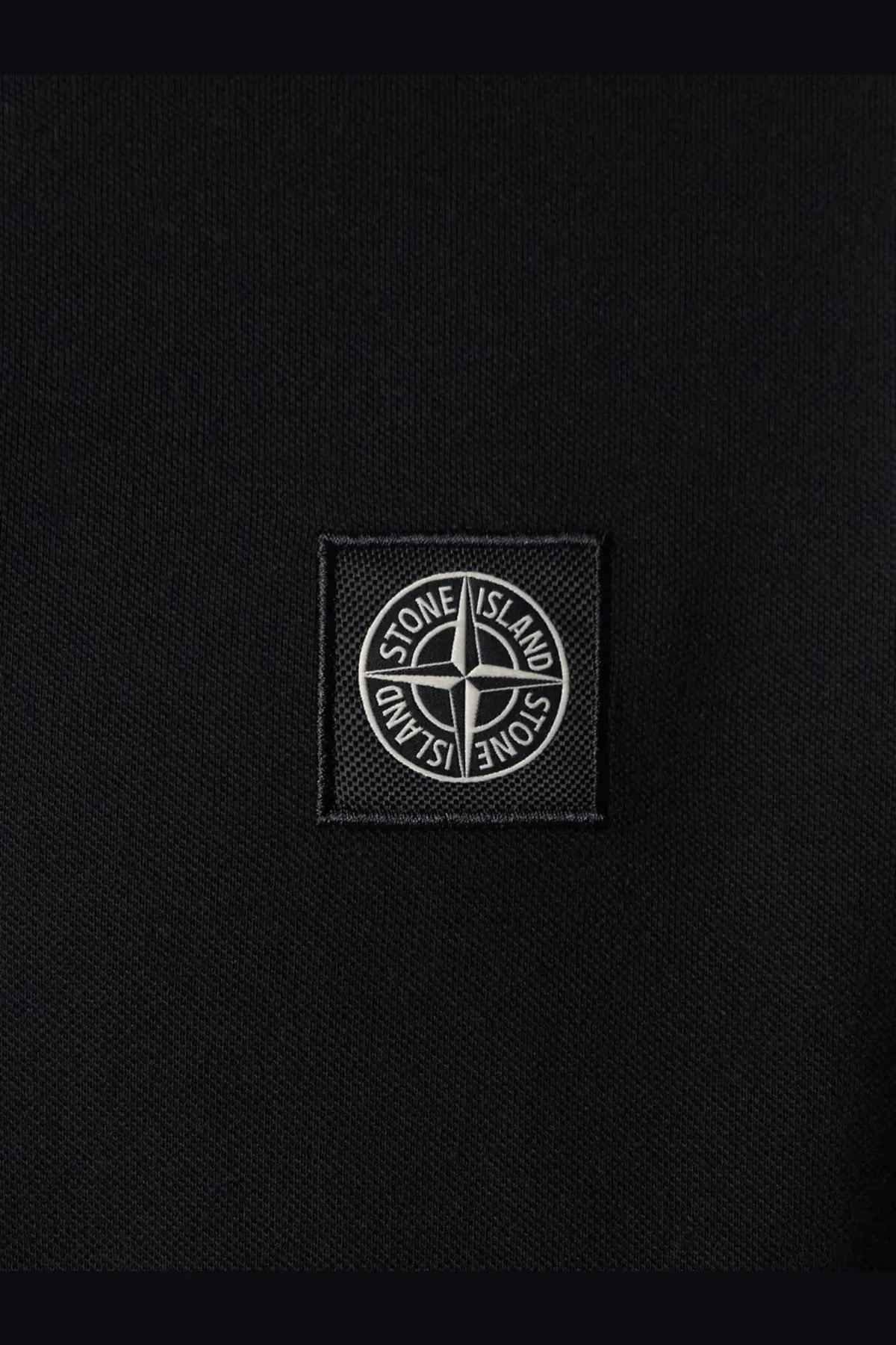 Stone Island men’s black polo shirt made of stretch organic cotton with a white embroidered compass patch
