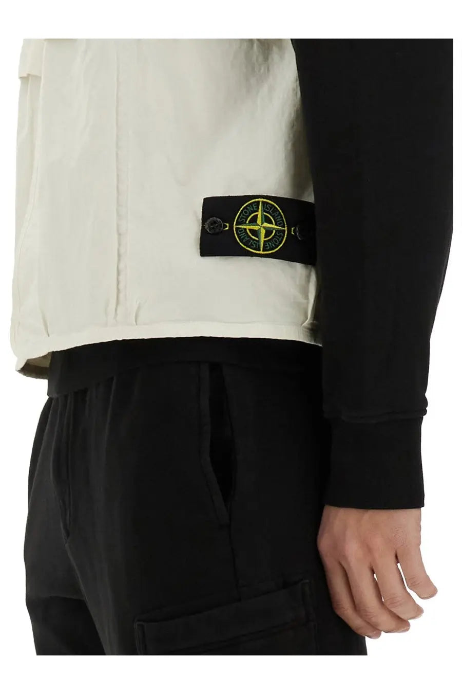 Stone Island men’s cream-colored utility vest with black patch and yellow compass logo for casual wear