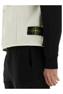 Stone Island men’s cream-colored utility vest with black patch and yellow compass logo for casual wear
