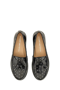 Black patent leather loafers by stuart weitzman with silver stud detailing and tassel accents for women