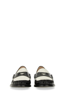 Black and white leather Stuart Weitzman women’s moccasin Lottie multicolor loafers with glossy finish and braided sides