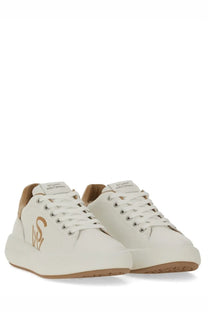 Stuart Weitzman women’s SW Pro sneaker white leather with tan accents gold logo silver eyelets and tan rubber sole