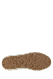 Tan rubber sole with embossed stuart weitzman logo pattern and white sidewall on womens sw pro sneaker white